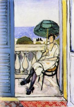 woman with a green parasol on a balcony